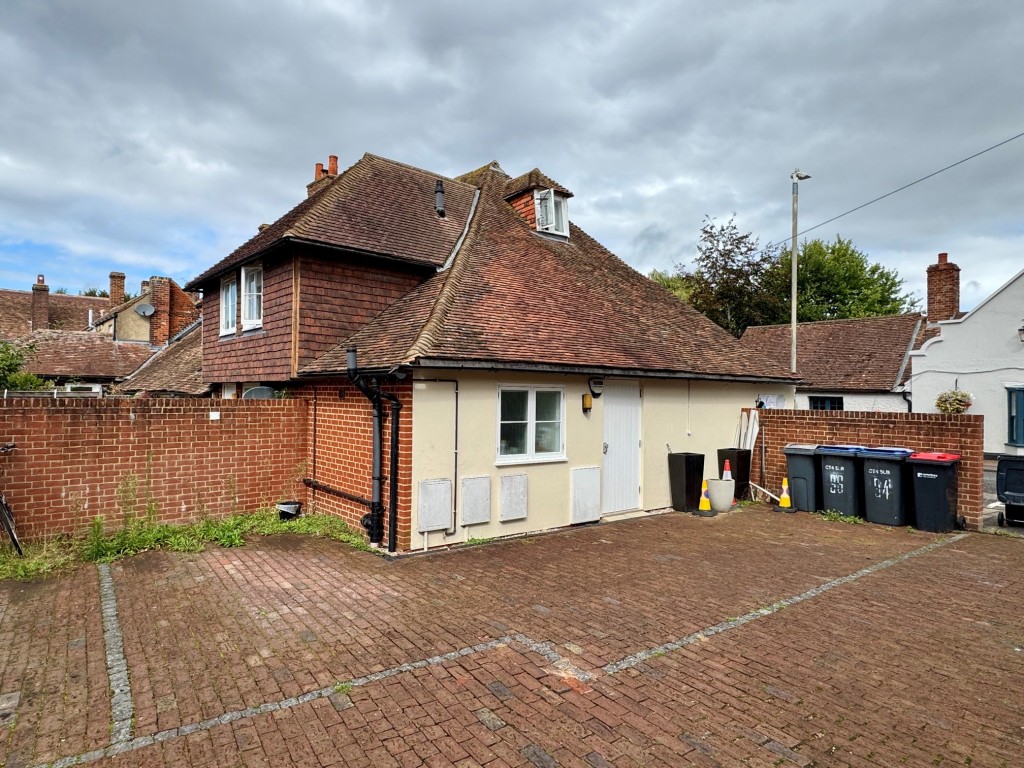 Lot: 88 - PERIOD FREEHOLD DOUBLE-FRONTED SHOP AND FLAT IN POPULAR VILLAGE LOCATION - Side view showing parking area